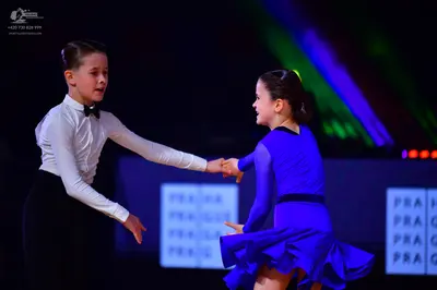 Dancesport competitor: Male dancer: white long-sleeved shirt, black bow tie, and black trousers