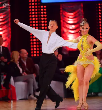 Dancesport competitor: Male dancer: white long-sleeved shirt with a deep V-neck and black trousers