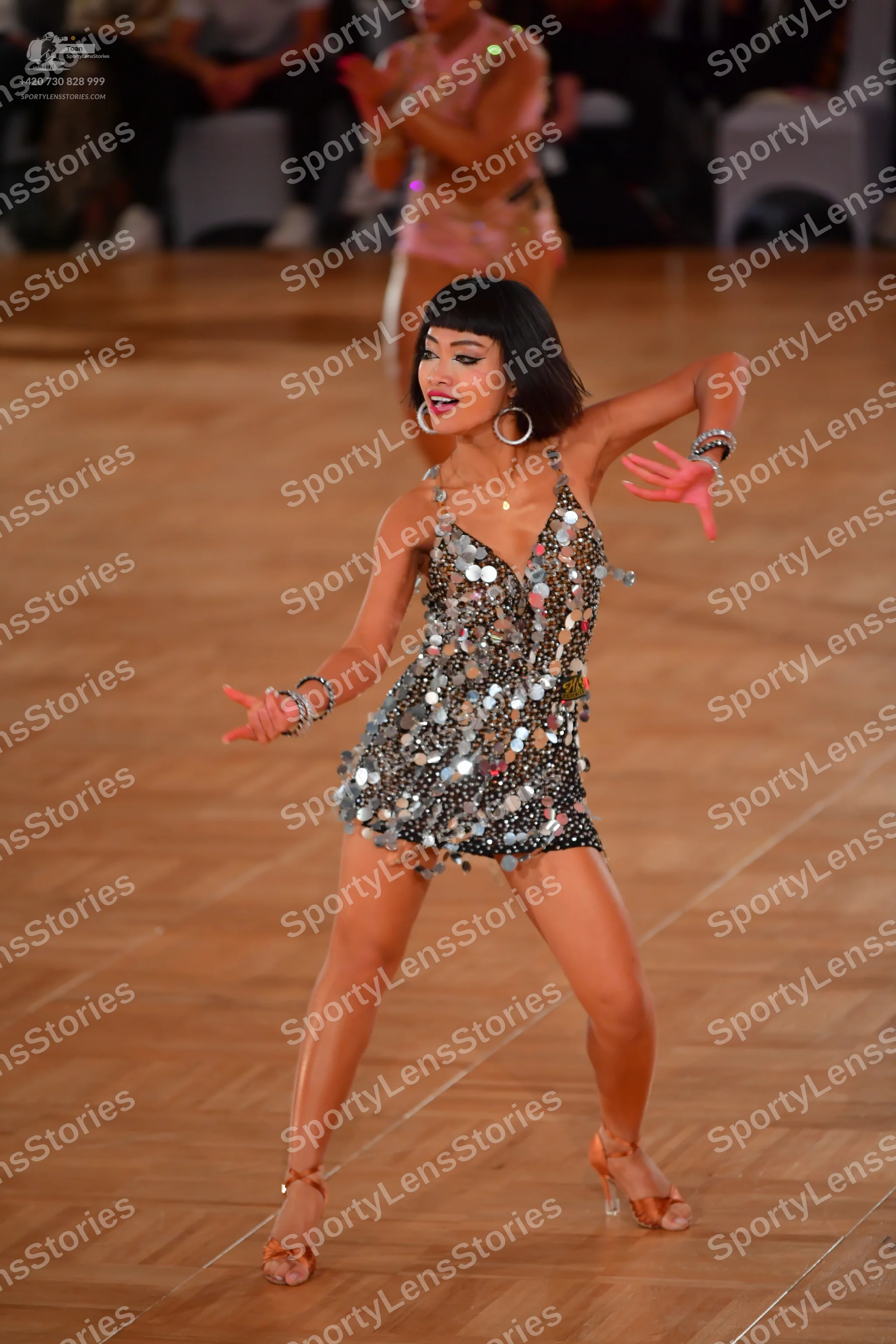 Dancesport competitor: Female dancer: silver latin dress covered in large silver sequins, sleeveless wi