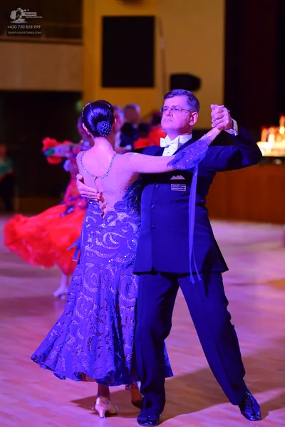 Dancesport competitor: Male:** Black tailsuit with sequin lapels