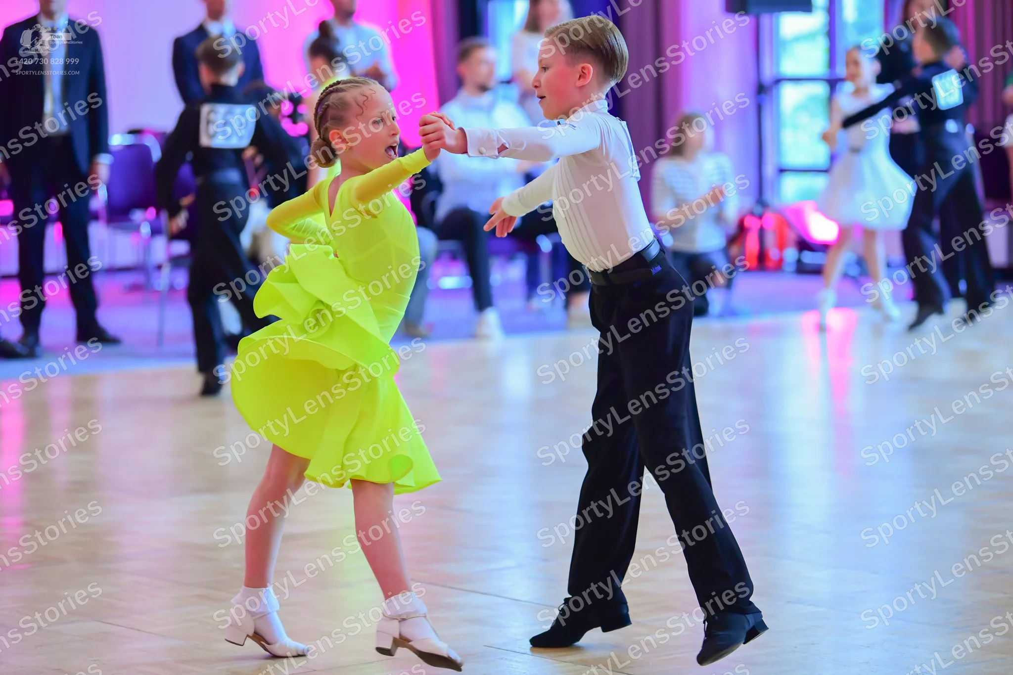 Dancesport competitor #668, #52: Foreground male dancer: white long-sleeved shirt and black trousers