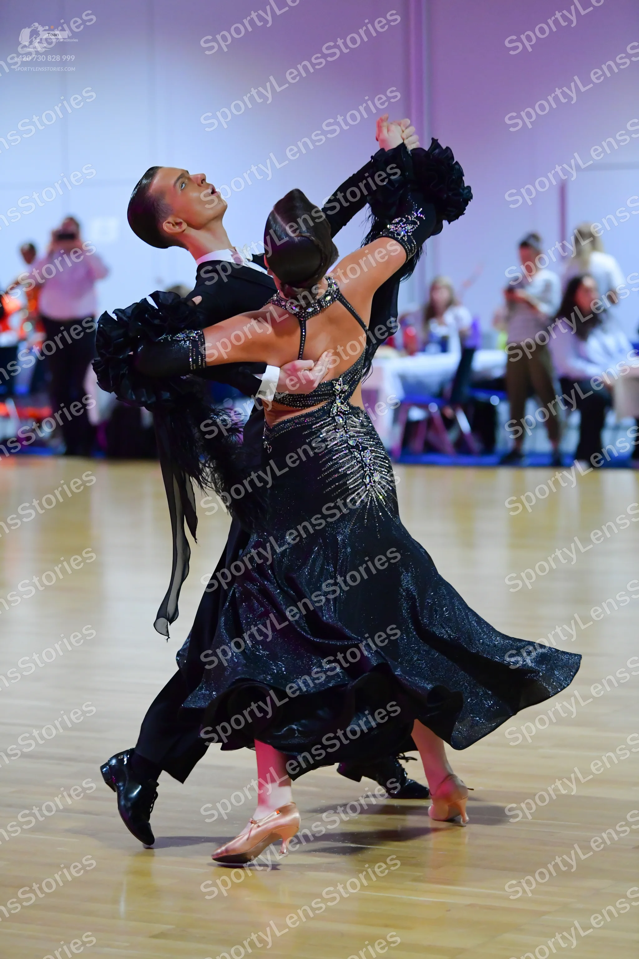 Dancesport competitor: Male dancer: black long-sleeved dance shirt with voluminous ruffled sleeves and 