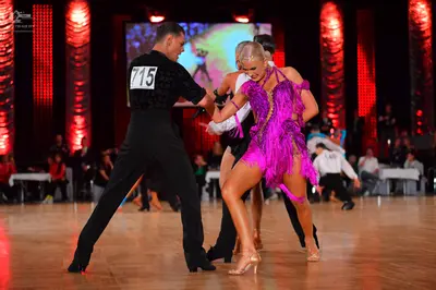 Dancesport competitor #715: Male dancer: black long-sleeved shirt and black trousers