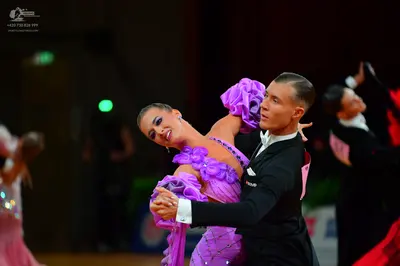 Dancesport competitor: Female dancer: lavender latin dress with large purple ruffles and sparkly embell