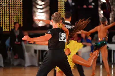 Dancesport competitor #834: Male dancer: black short-sleeved t-shirt and black trousers
