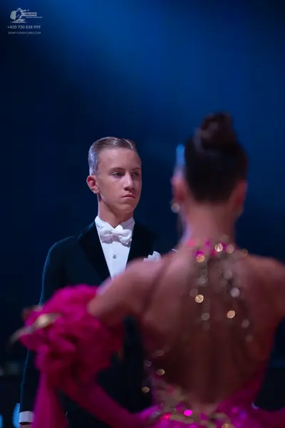 Dancesport competitor: Male dancer: black suit with a white shirt and white bowtie