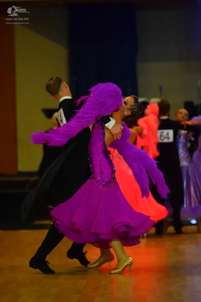 Dancesport competitor #64: Male dancer (foreground): black ballroom suit with a white shirt and black trous