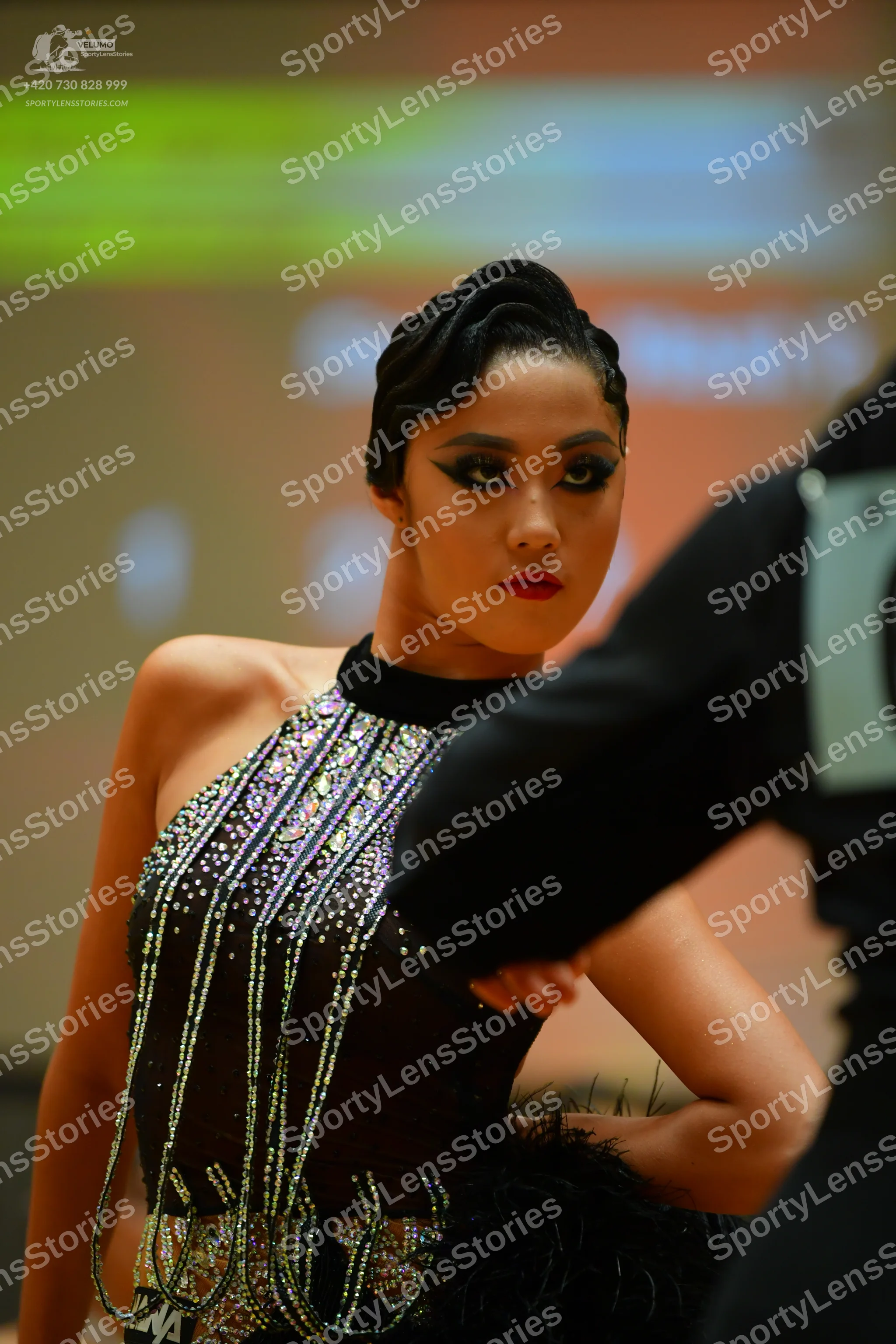 Dancesport competitor: Female dancer: black latin dress with a halter neck, heavily embellished with si
