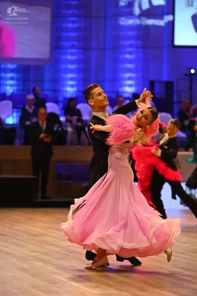 Dancesport competitor: Male dancer: black suit with a white shirt