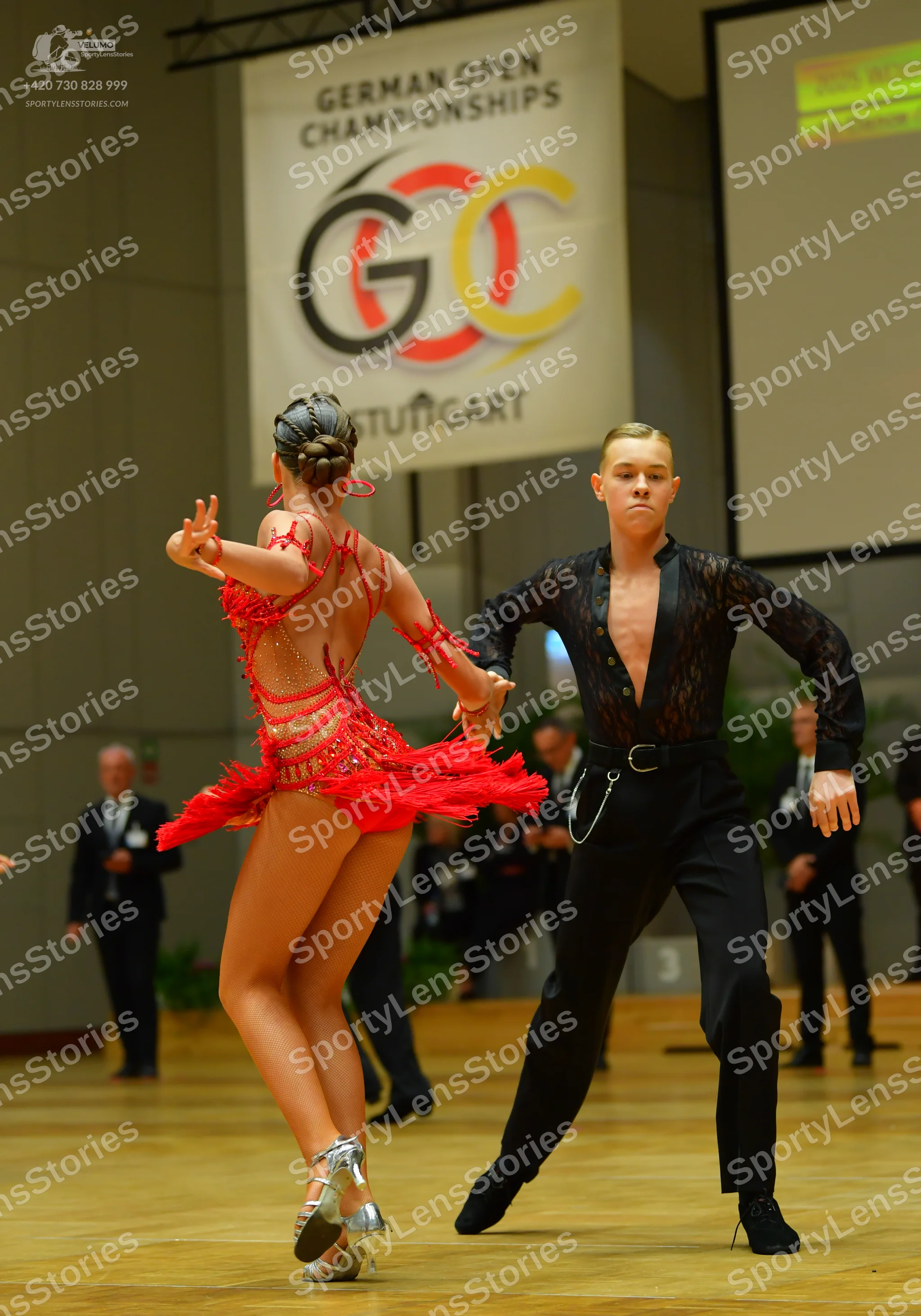 Dancesport competitor: Female dancer: red latin dress with fringe and thin straps