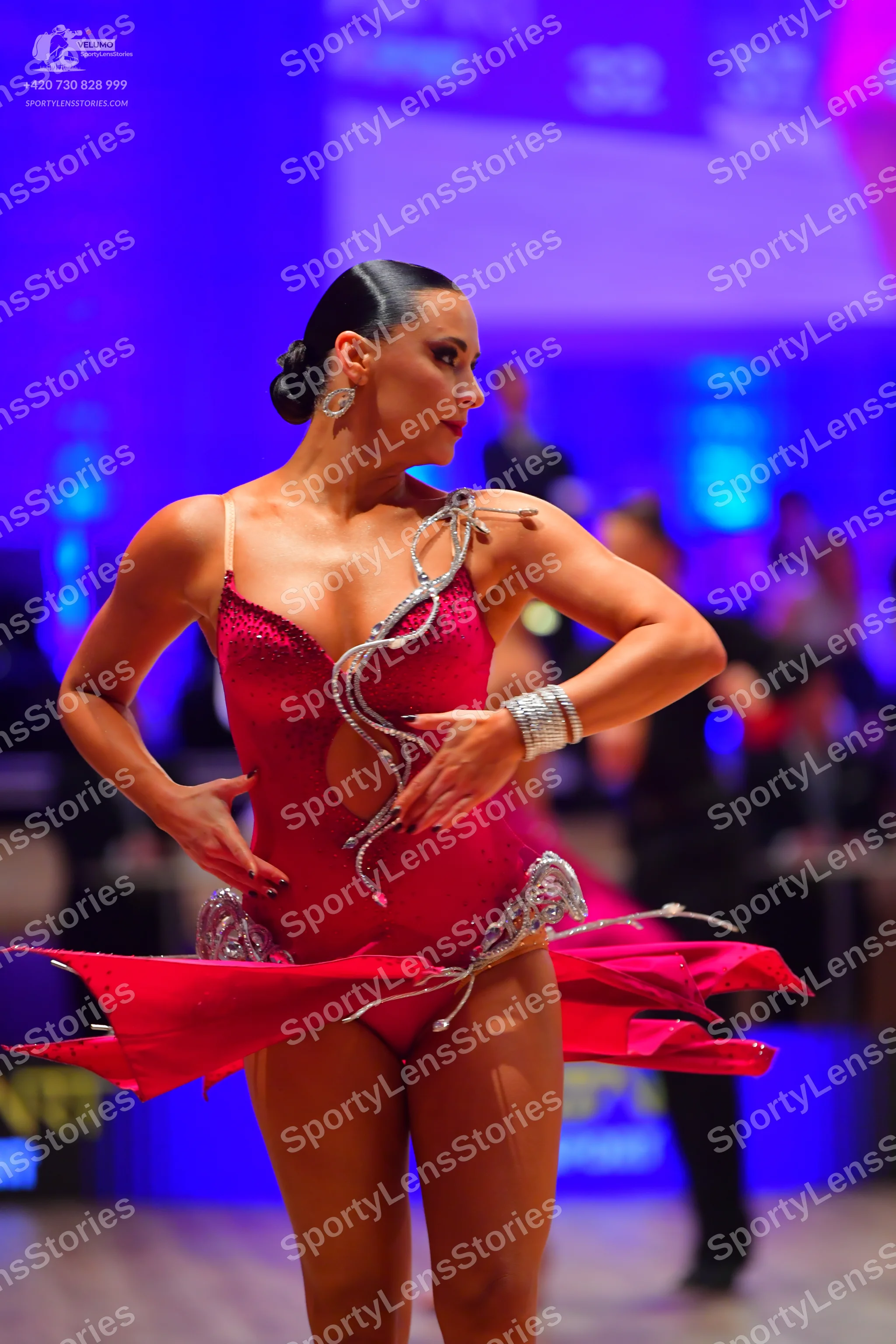 Dancesport competitor: Female dancer: red sequined Latin dance costume with silver rhinestone embellish