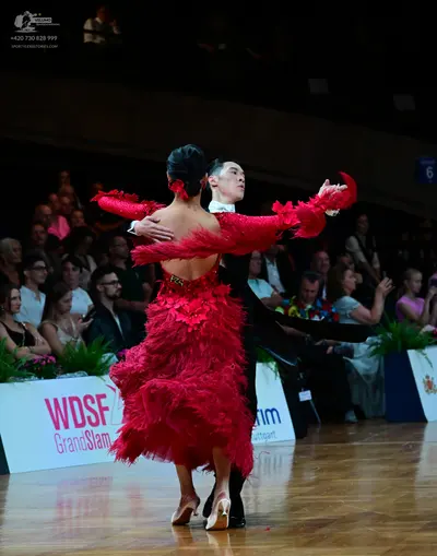 Dancesport competitor #75: Female dancer: red Latin dress with long sleeves and layers of red feathers or r