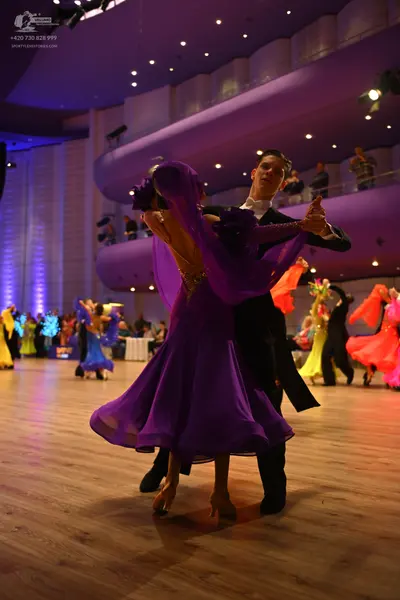 Dancesport competitor: Male dancer: black formal suit or tailcoat with a white shirt and white bow tie