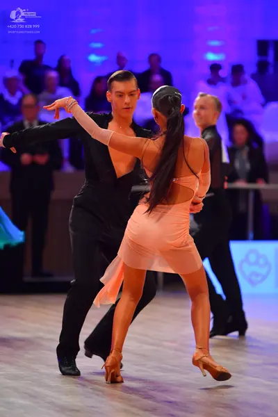 Dancesport competitor: Male dancer: black long-sleeved top and black trousers