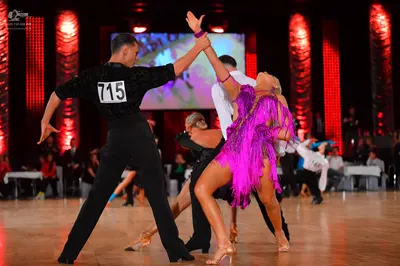 Dancesport competitor #715: Male dancer: black long-sleeved shirt and black trousers