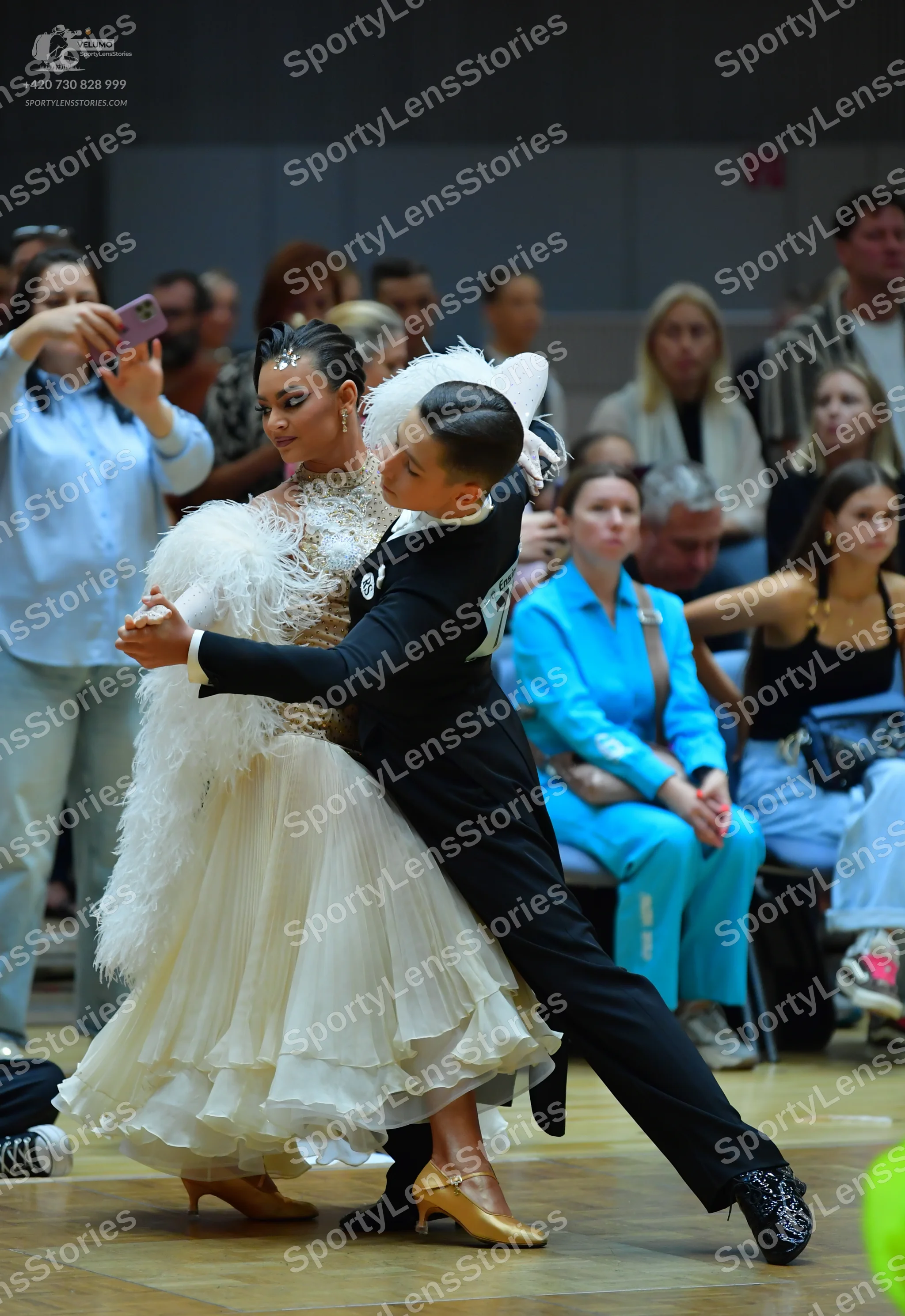 Dancesport competitor: Female dancer: white/ivory ballgown with a lace bodice and a voluminous, layered