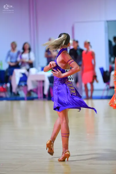 Dancesport competitor #33: Female dancer: purple latin dress with a sequined bodice and a flared skirt, pai