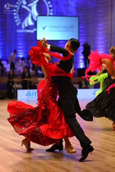Dancesport competitor: Male dancer: black dance shirt with red accents
