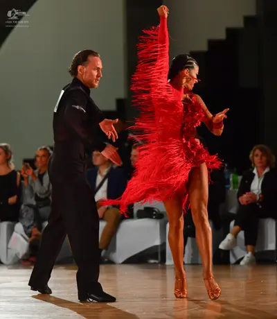 Dancesport competitor: Male dancer: black long-sleeved shirt and black trousers