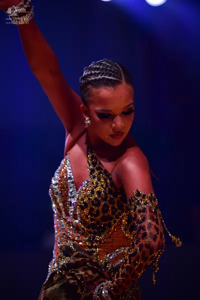 Dancesport competitor: Female dancer: leopard print latin dress with silver sequins and rhinestones, fe