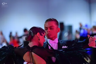 Dancesport competitor: Male dancer: black suit with a white shirt and white bow tie