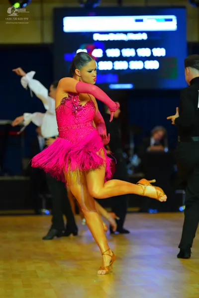 Dancesport competitor #42, #103: Female dancer: hot pink latin dress with sequins and fringe