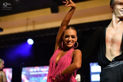 Dancesport competitor: ** Red Latin Dress
*   **Color:** Primarily red
*   **Fabric:** Appears to be sa