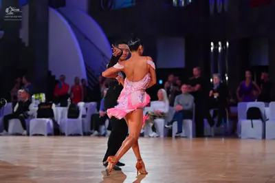 Dancesport competitor: Female dancer: pink latin dress with ruffles