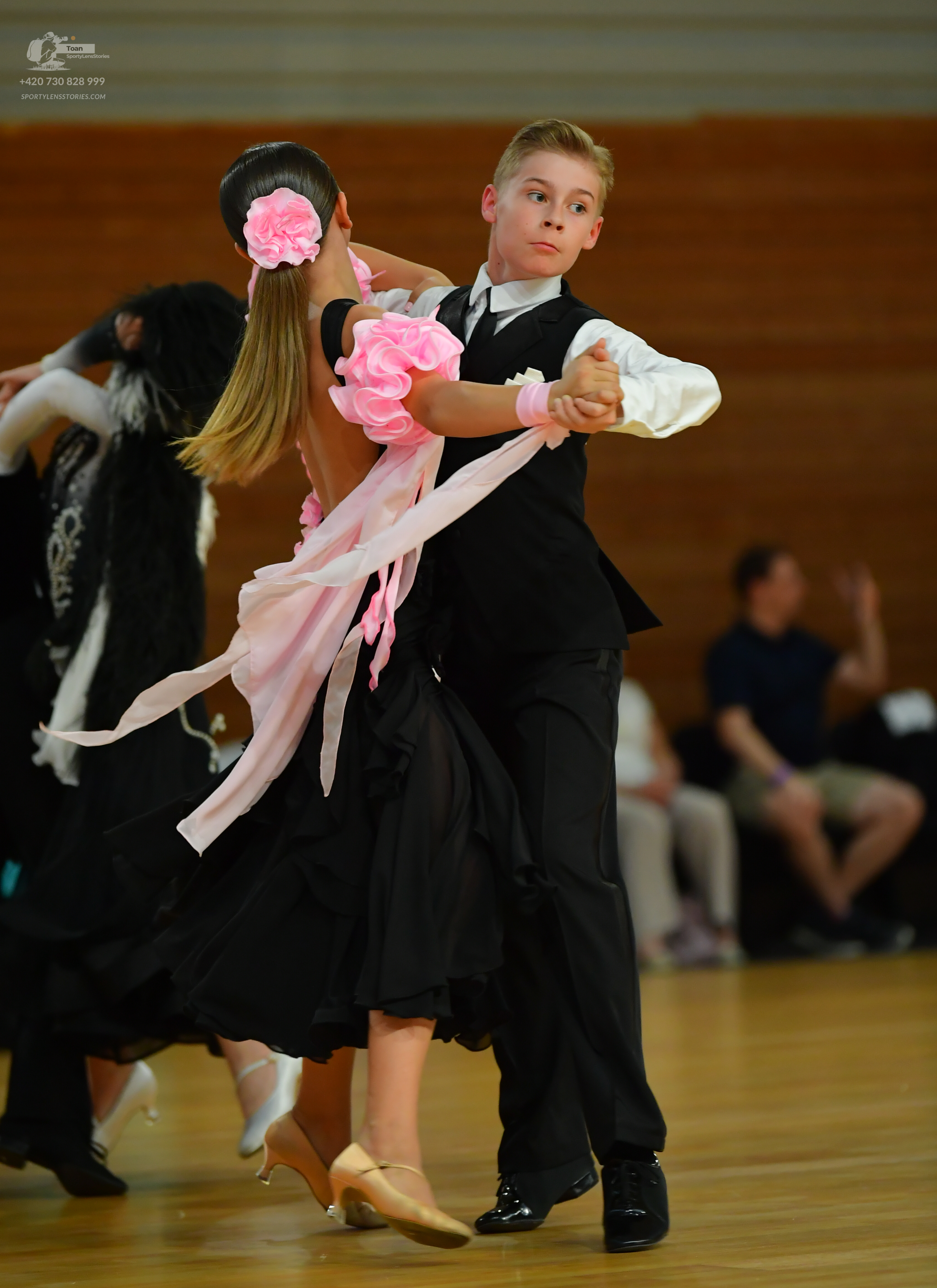 Dancesport competitor: ** Black tail suit
*   **Fabric:** Satin
*   **Style:** Tail suit with a fitted 