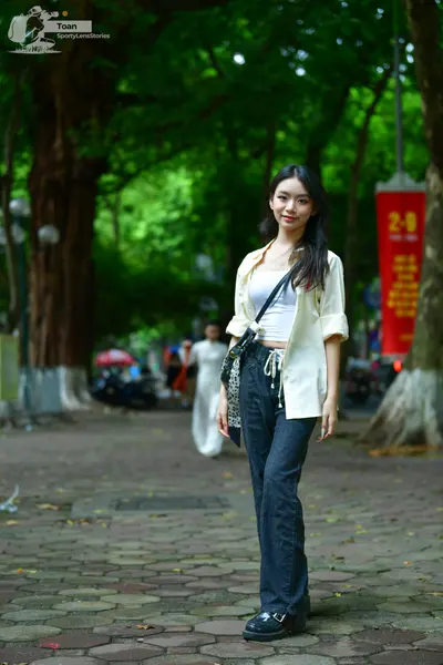 Dancesport competitor: Female dancer (foreground): white unbuttoned long-sleeved shirt over a white tan