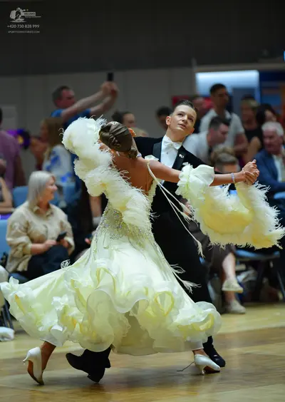 Dancesport competitor: Male dancer: black formal suit with a white shirt and white bow tie
