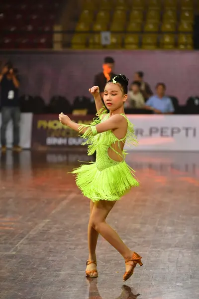 Dancesport competitor: Female dancer: lime green Latin dress with fringe