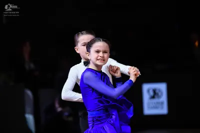 Dancesport competitor: Male dancer: white long-sleeved shirt with a black bow tie
