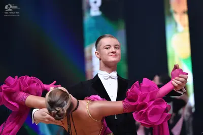 Dancesport competitor: Male dancer: black suit with a white shirt and white bow tie