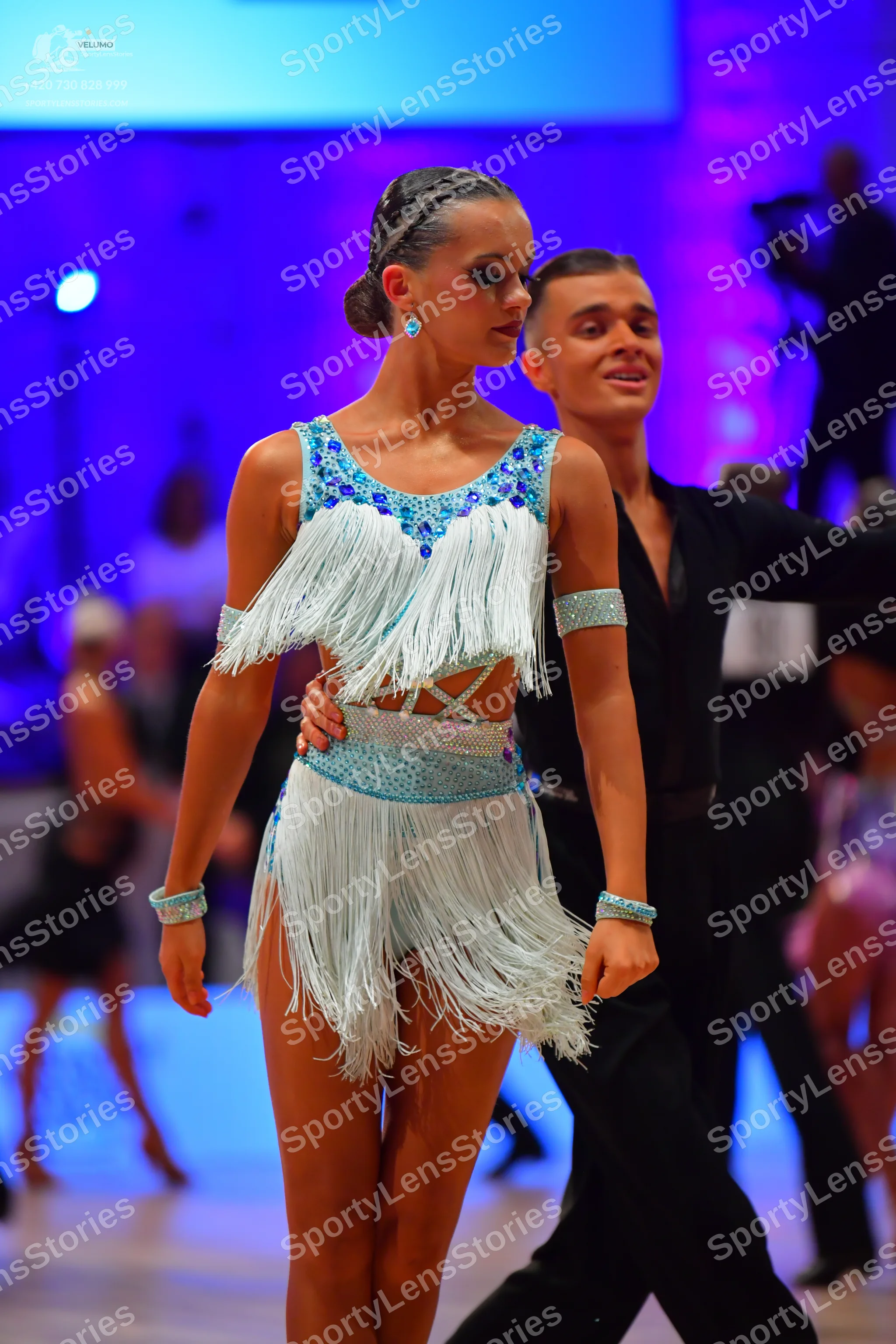 Dancesport competitor: Female dancer: light blue Latin dress with blue sequins around the neckline and