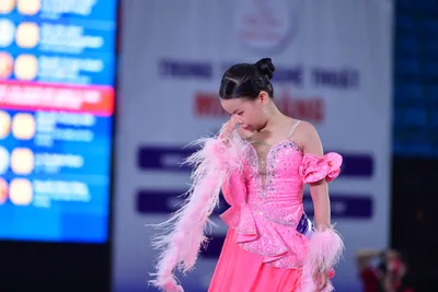 Dancesport competitor: Here's a breakdown of the dancers’ costumes in the photo:

**Dancer 1 (Female):*