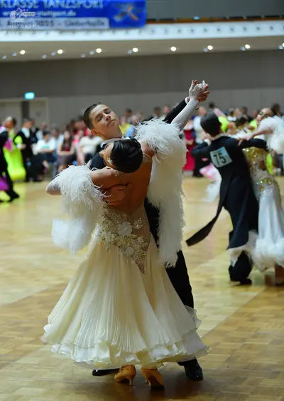 Dancesport competitor #75: Male dancer (foreground): black ballroom suit with a white shirt