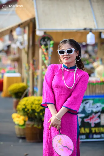 Dancesport competitor: Female dancer: bright pink long-sleeved dress with a textured pattern and teal t