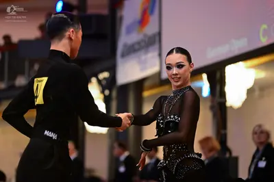 Dancesport competitor: Male dancer: black long-sleeved top