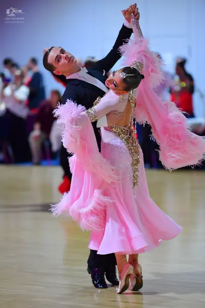 Dancesport competitor: Male dancer: black suit with a white shirt and a black bow tie
