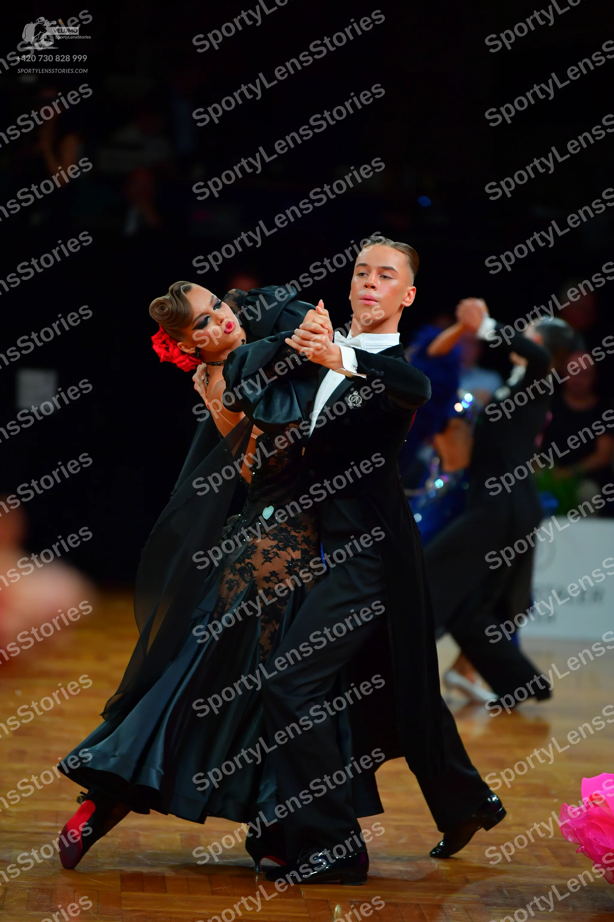 Dancesport competitor: Female dancer: black ballroom dress with a lace bodice and a long, flowing skirt