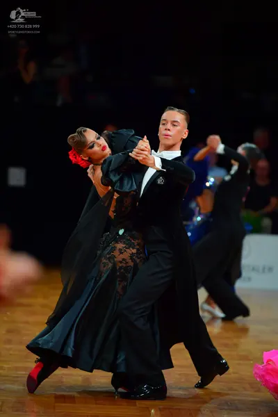 Dancesport competitor: Female dancer: black ballroom dress with a lace bodice and a long, flowing skirt