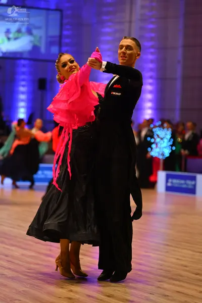 Dancesport competitor: Male dancer: black long-sleeved shirt and black trousers