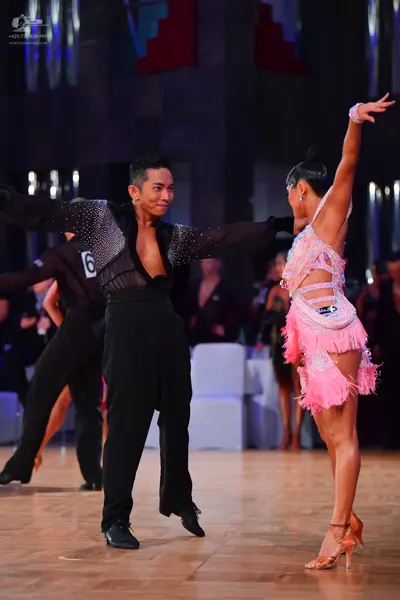 Dancesport competitor: Male dancer: black long-sleeved shirt with sequins and black trousers