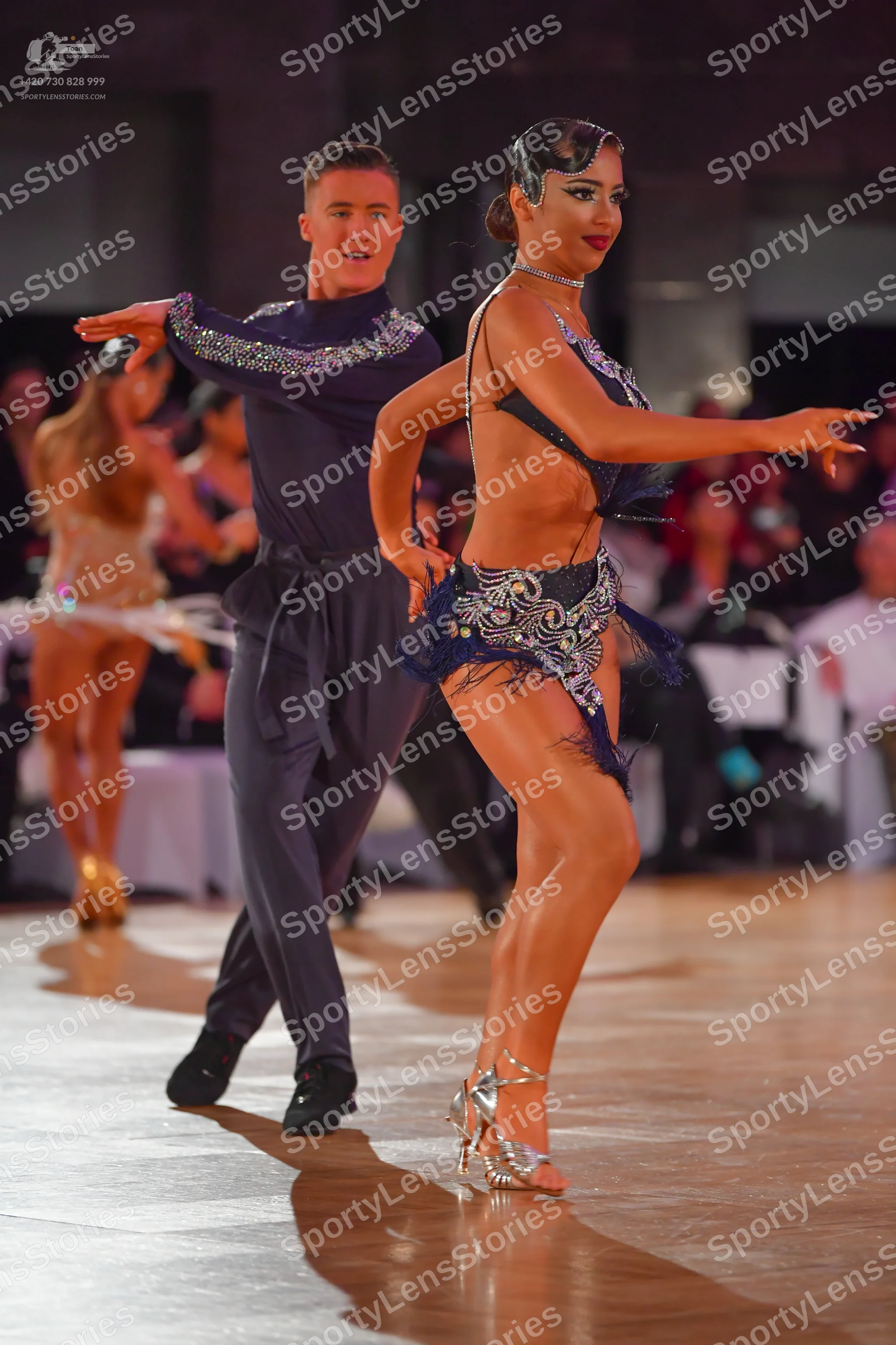 Dancesport competitor: Male dancer: dark navy blue long-sleeved shirt with silver sequin embellishments