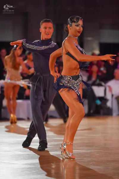 Dancesport competitor: Male dancer: dark navy blue long-sleeved shirt with silver sequin embellishments