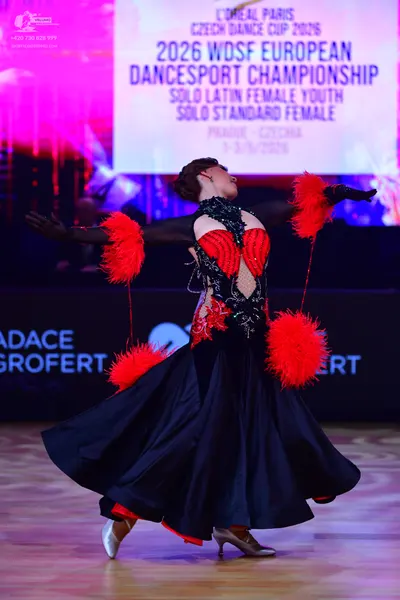 Dancesport competitor: Female dancer: black ballroom dress with a red and black sequined and lace bodic
