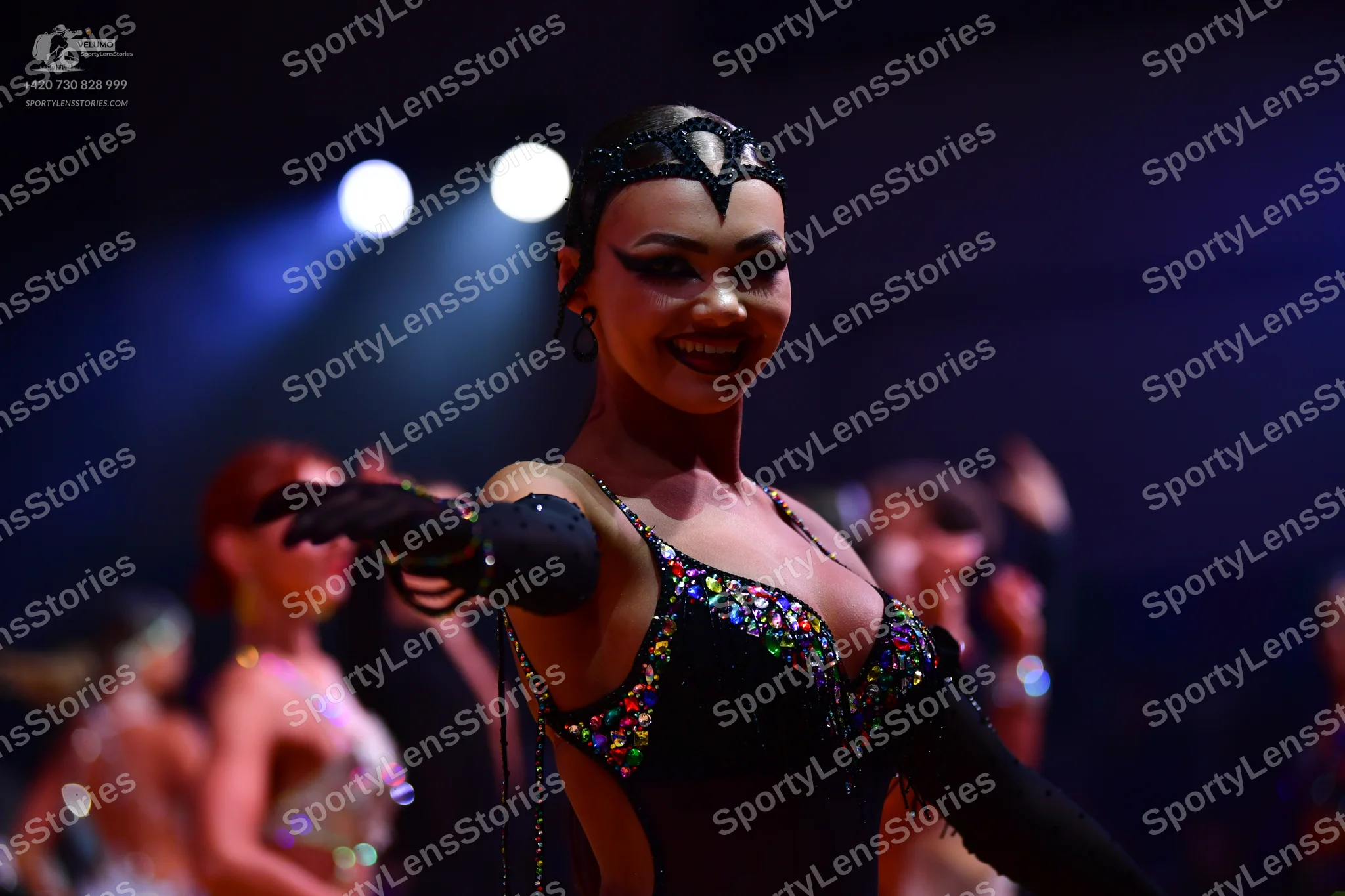 Dancesport competitor: Main dancer: black latin-style dress with multi-colored sequins (pink, blue, yel