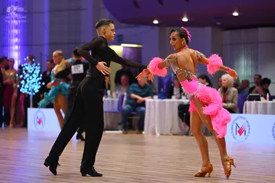 Dancesport competitor: Male dancer: black long-sleeved top and black trousers