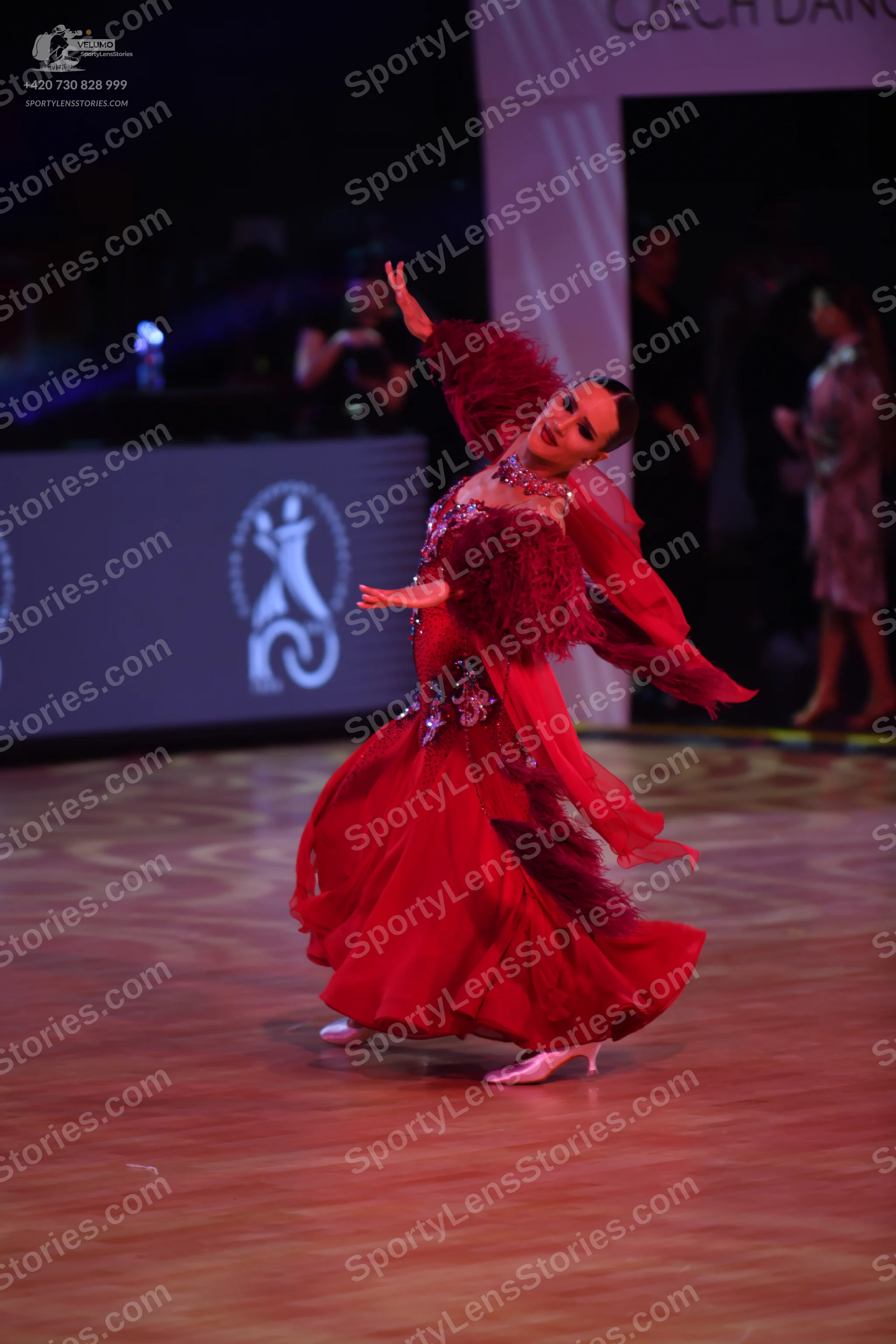 Dancesport competitor: Female dancer: red ballroom dress with a voluminous skirt and a sequined bodice